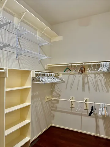 a view of a room with a window and wooden floor