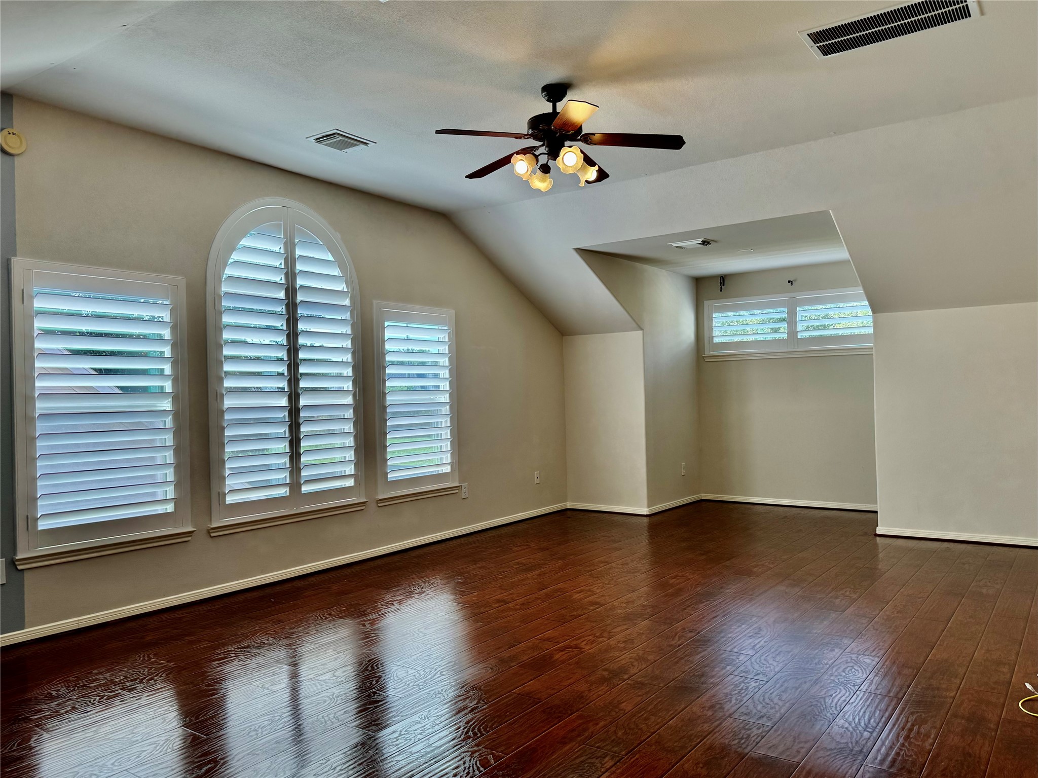 15434 Bay Tree Landing Cypress, TX 77429 - Photo 28 of 39 an empty room with wooden floor chandelier and windows
