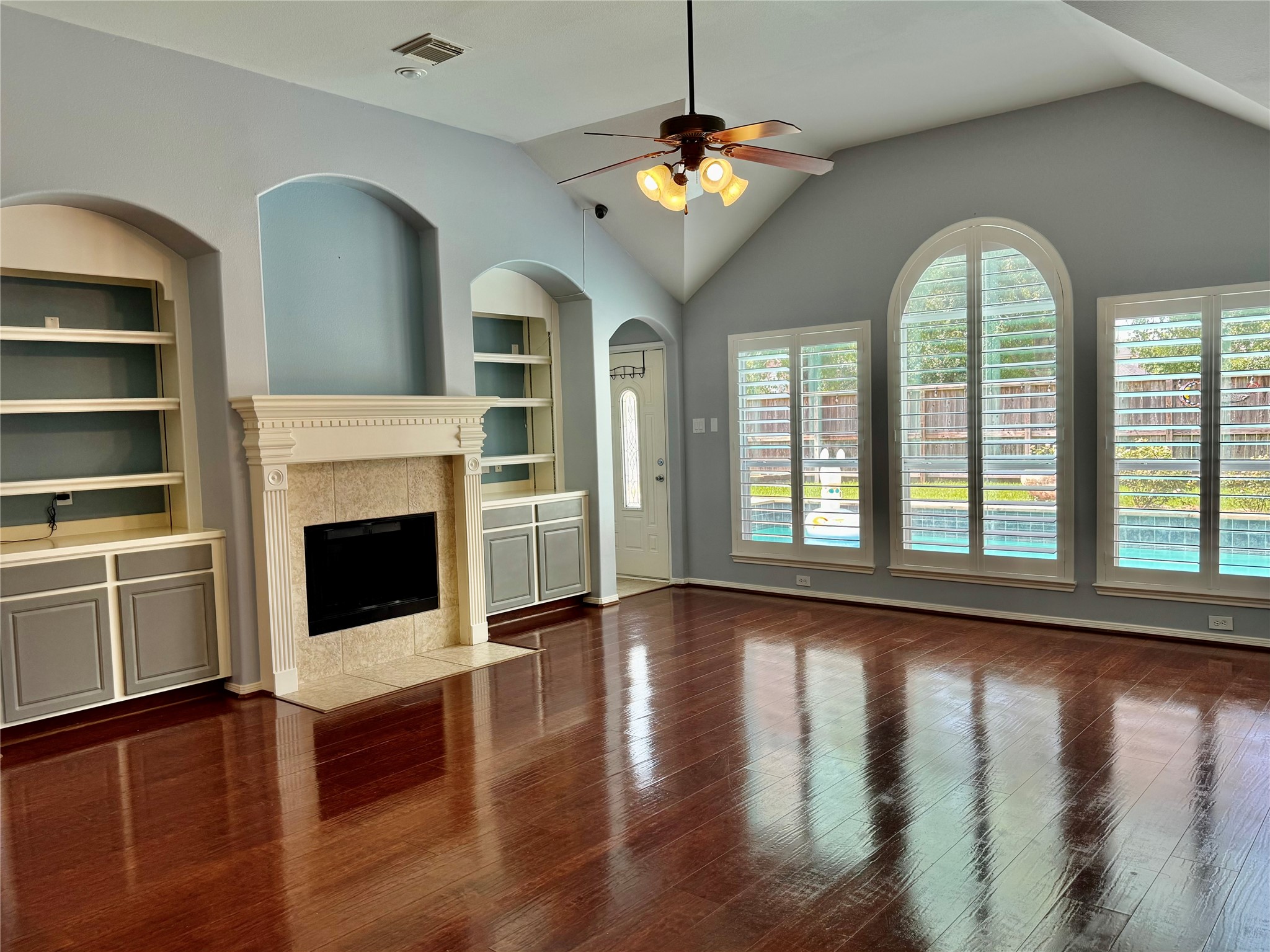 15434 Bay Tree Landing Cypress, TX 77429 - Photo 7 of 39 a view of an empty room with wooden floor fireplace and a window