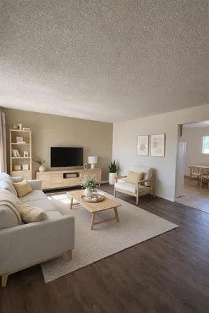 a living room with furniture wooden floor and a flat screen tv