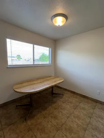 a view of a room with a window and wooden floor
