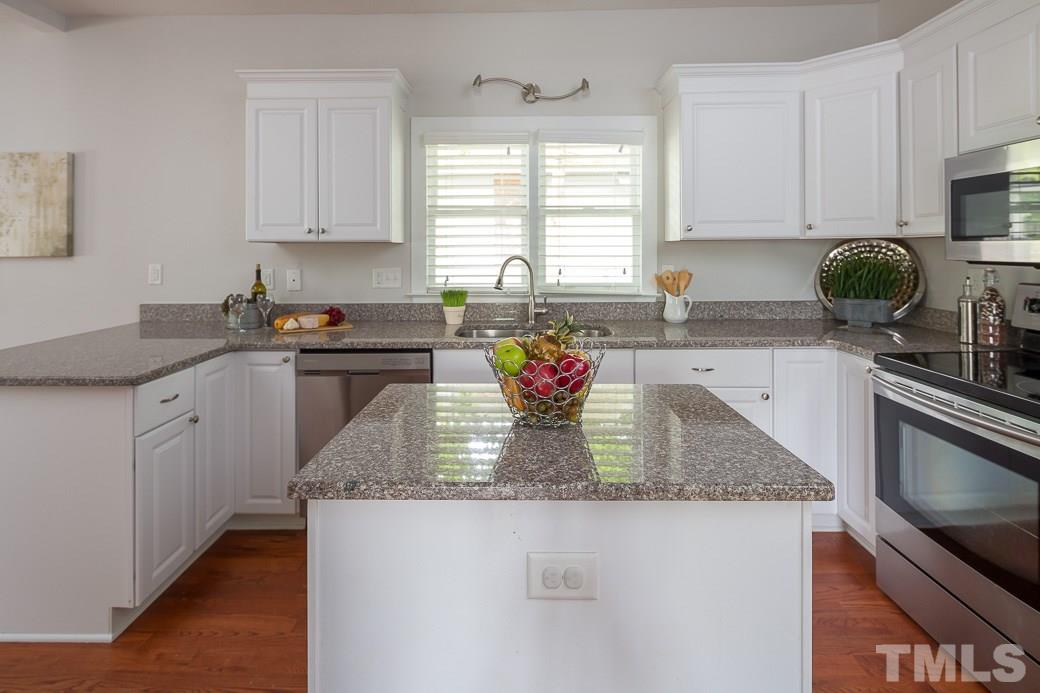 904 East Edenton Street Raleigh, NC 27601 - Photo 3 of 11 a kitchen with stainless steel appliances granite countertop a sink a stove counter space and cabinets