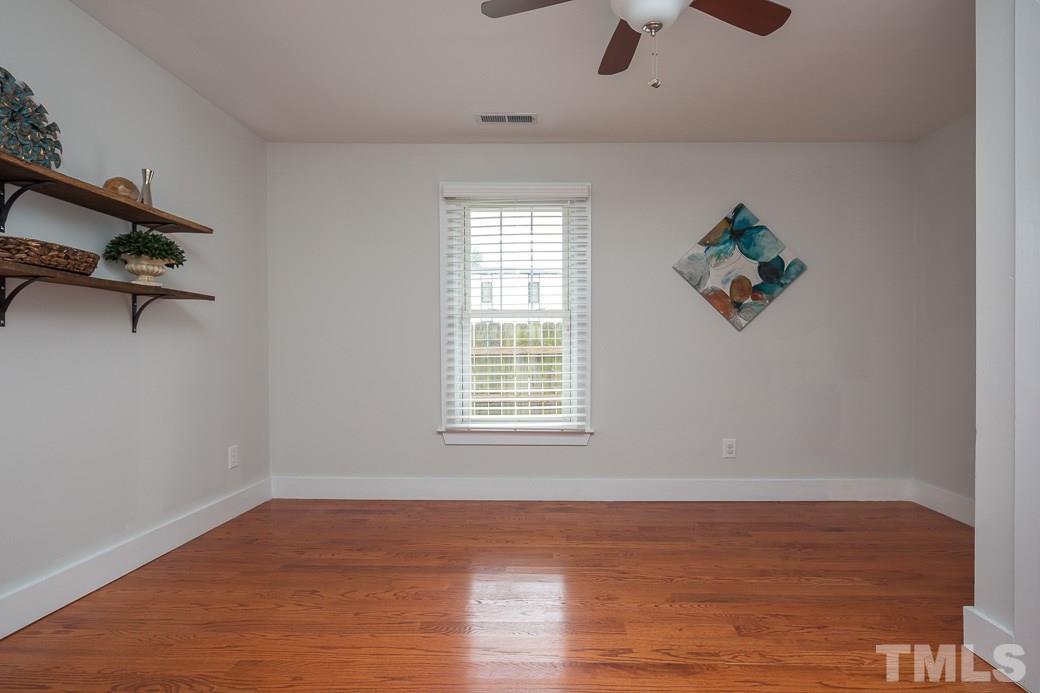 904 East Edenton Street Raleigh, NC 27601 - Photo 6 of 11 a view of an empty room with wooden floor and a window
