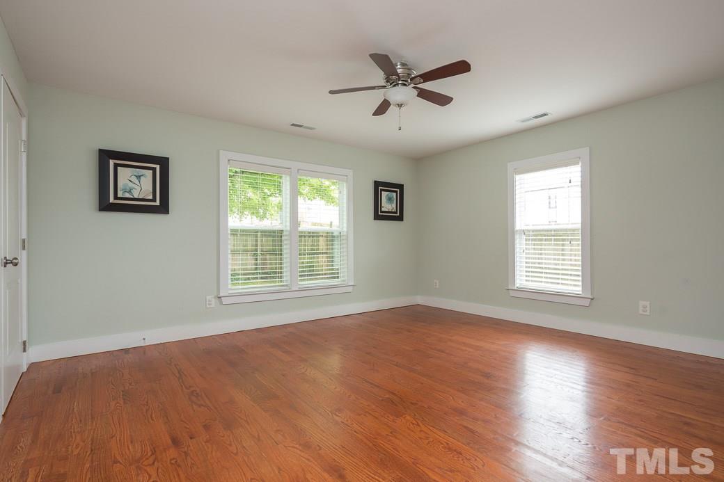 904 East Edenton Street Raleigh, NC 27601 - Photo 8 of 11 a view of a big room with wooden floor and windows