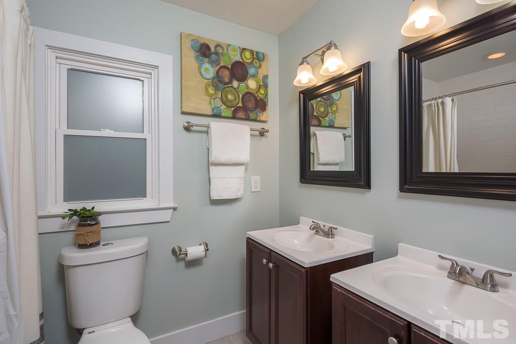 904 East Edenton Street Raleigh, NC 27601 - Photo 9 of 11 a bathroom with 2 sink and a toilet