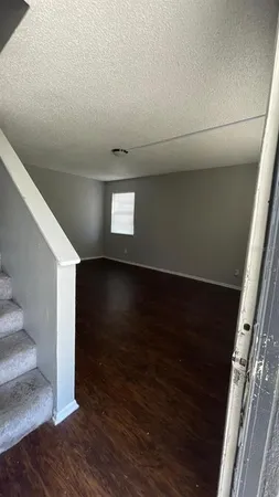 a view of an empty room and wooden floor