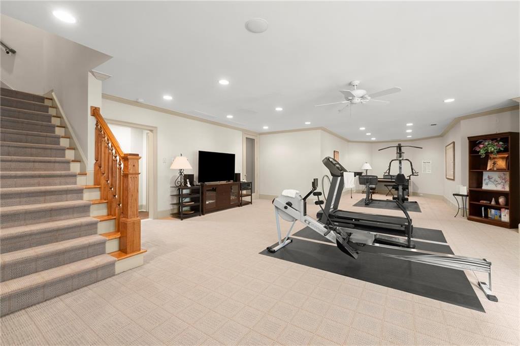 322 Edwards Brook Lane Canton, GA 30115 - Photo 68 of 99 a view of a room with gym equipment and a flat screen tv