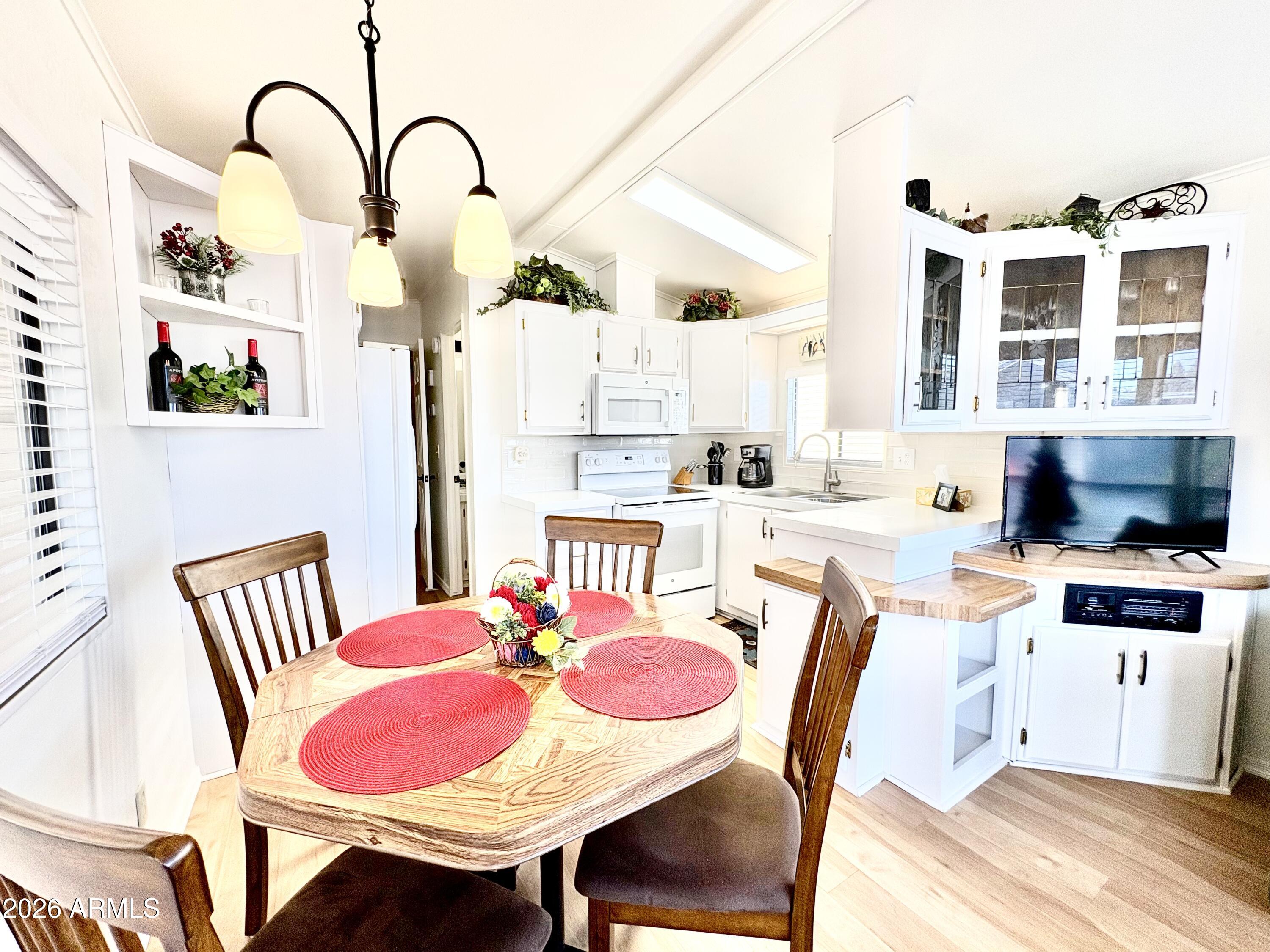 111 South Greenfield Road, Unit 589 Mesa, AZ 85206 - Photo 19 of 54 a dining room with furniture and wooden floor