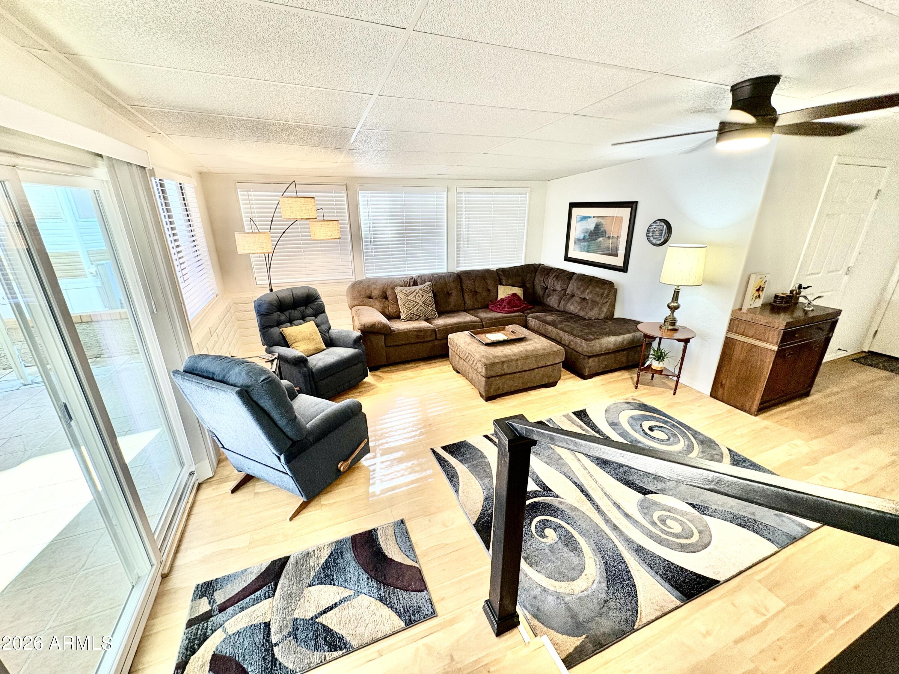 111 South Greenfield Road, Unit 589 Mesa, AZ 85206 - Photo 2 of 54 a living room with furniture and a wooden floor