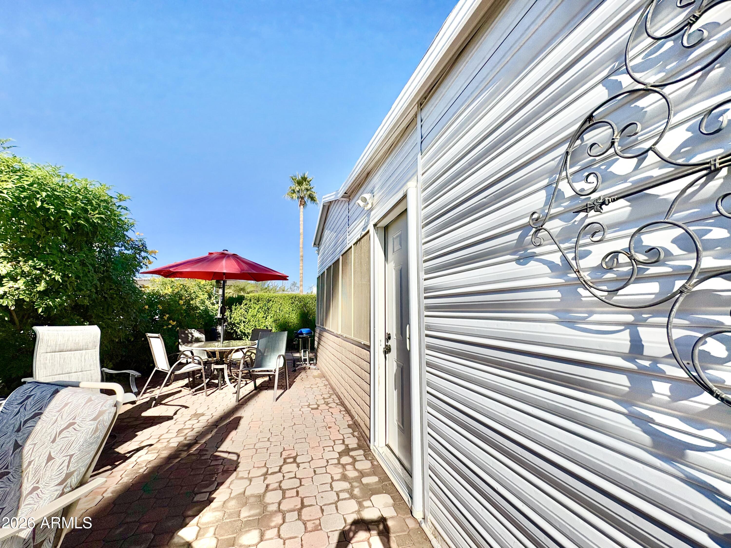 111 South Greenfield Road, Unit 589 Mesa, AZ 85206 - Photo 28 of 54 a view of a patio with furniture and a yard