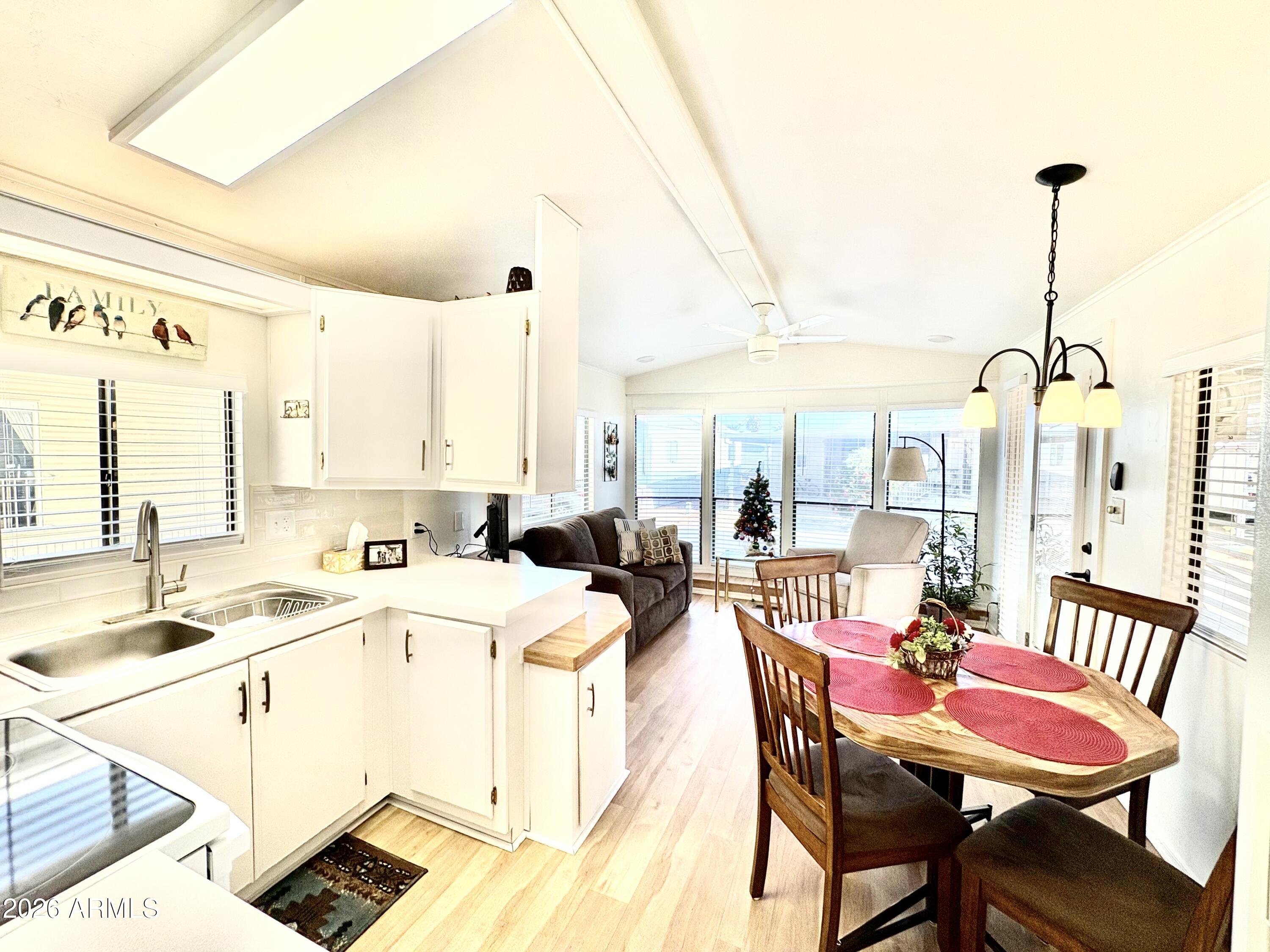 111 South Greenfield Road, Unit 589 Mesa, AZ 85206 - Photo 3 of 54 a room with stainless steel appliances kitchen island granite countertop furniture and a view of living room