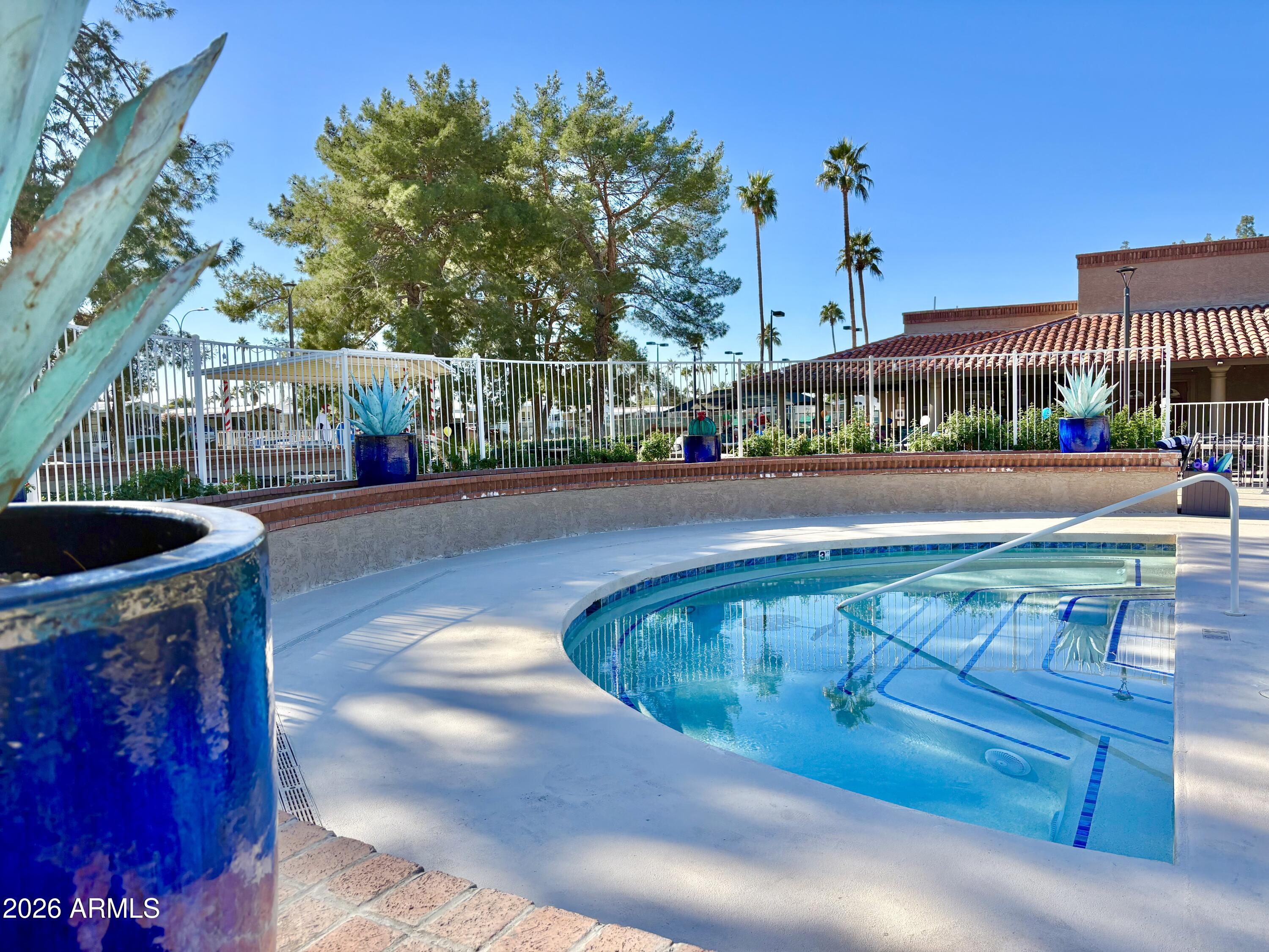 111 South Greenfield Road, Unit 589 Mesa, AZ 85206 - Photo 32 of 54 a view of a swimming pool with a patio
