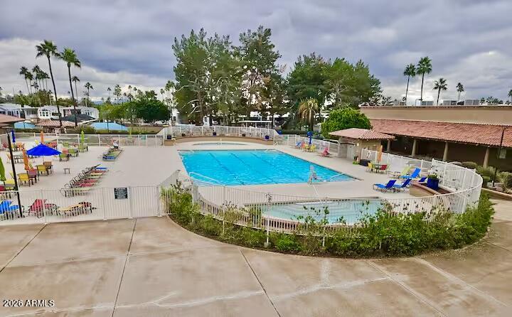 111 South Greenfield Road, Unit 589 Mesa, AZ 85206 - Photo 39 of 54 a view of a swimming pool with a yard and potted plants