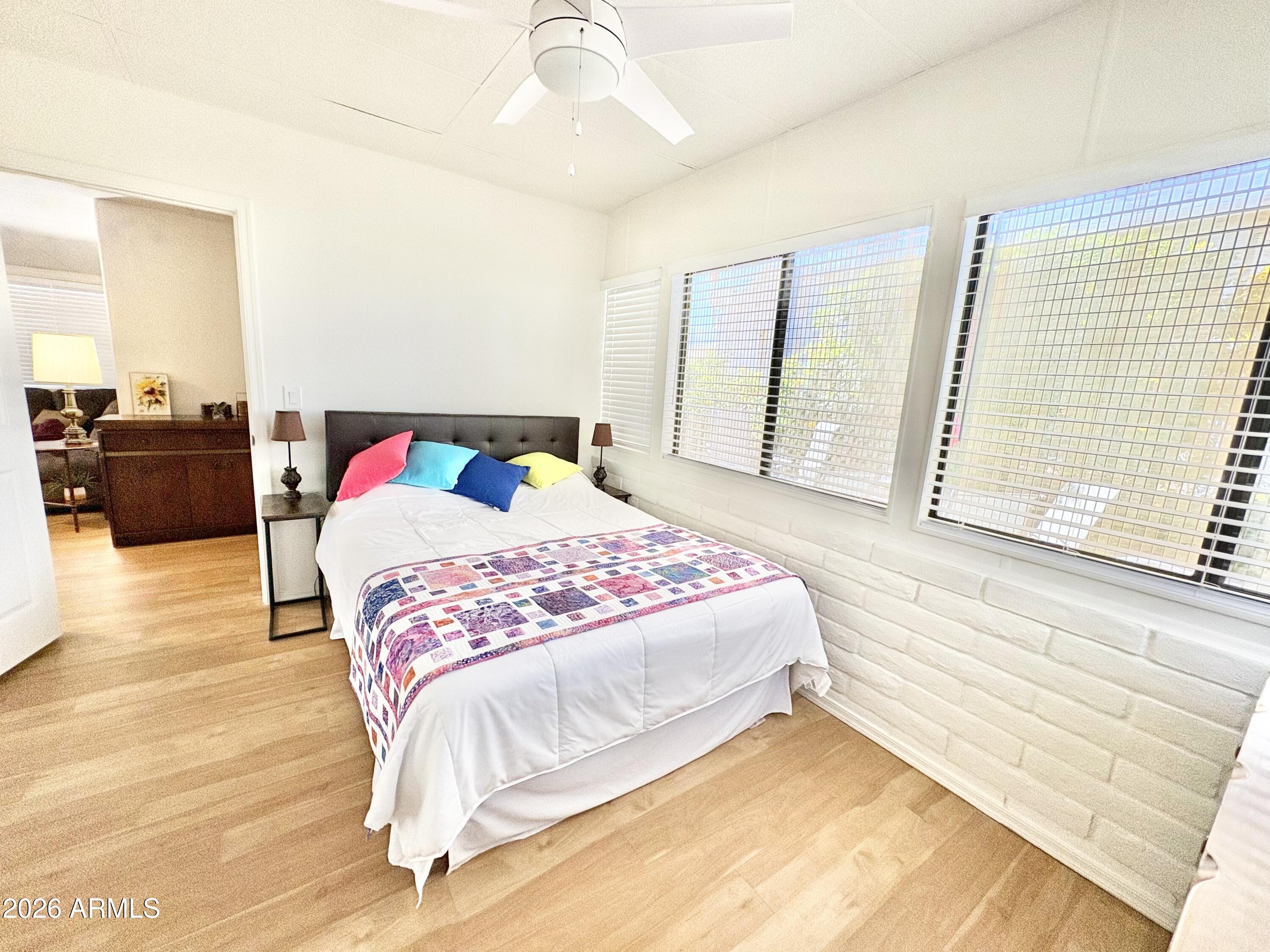 111 South Greenfield Road, Unit 589 Mesa, AZ 85206 - Photo 9 of 54 a bedroom with a bed and a large window