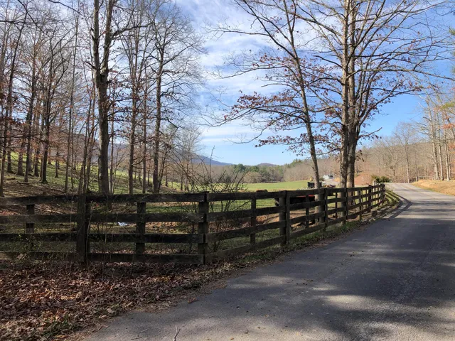 a view of a yard with wooden fence