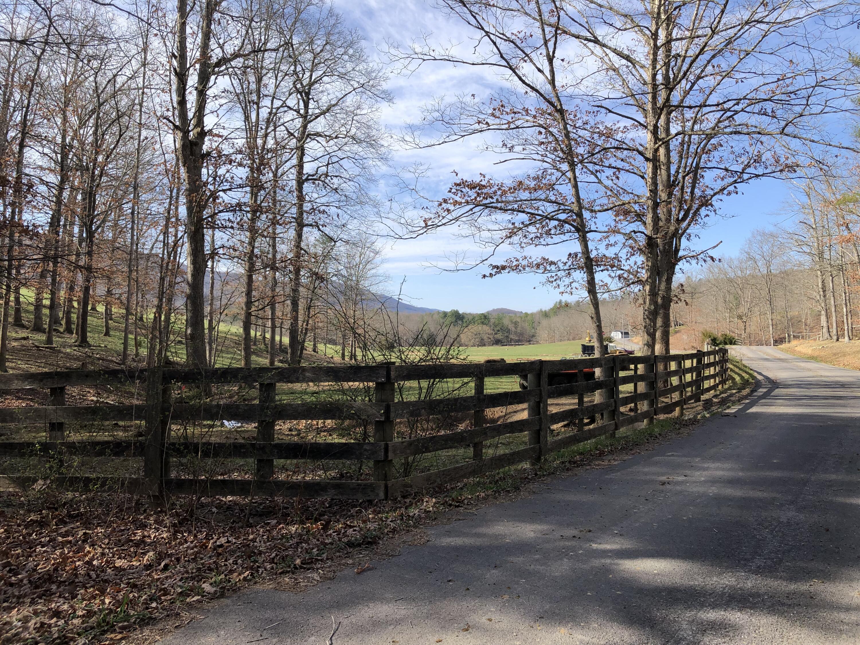a view of a yard with wooden fence