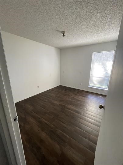 1101 Bois D'Arc Street, Unit D Lockhart, TX 78644 - Photo 5 of 8 an empty room with wooden floor and windows