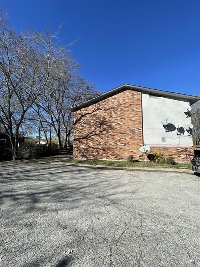 1101 Bois D'Arc Street, Unit D Lockhart, TX 78644 - Photo 8 of 8 a view of a pathway with a building in the background