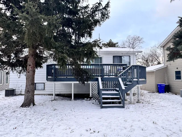 a view of a chairs setting in the back yard of the house