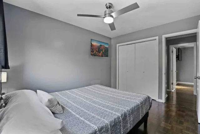 a bedroom with a bed and a chandelier