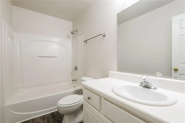 a bathroom with a sink toilet and a mirror