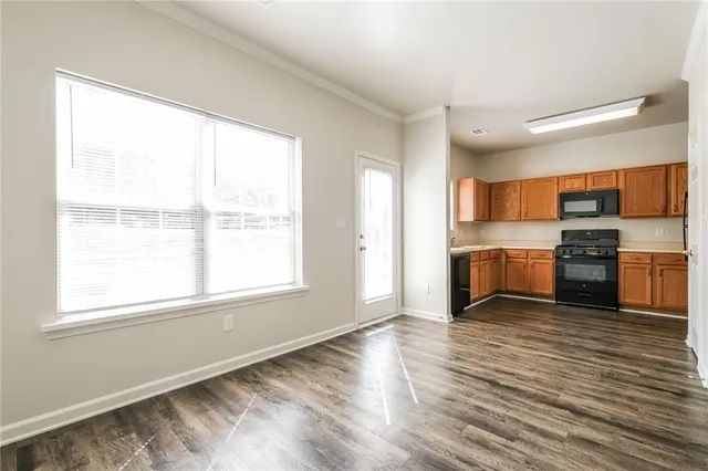 a view of kitchen with wooden floor electronic appliances and window