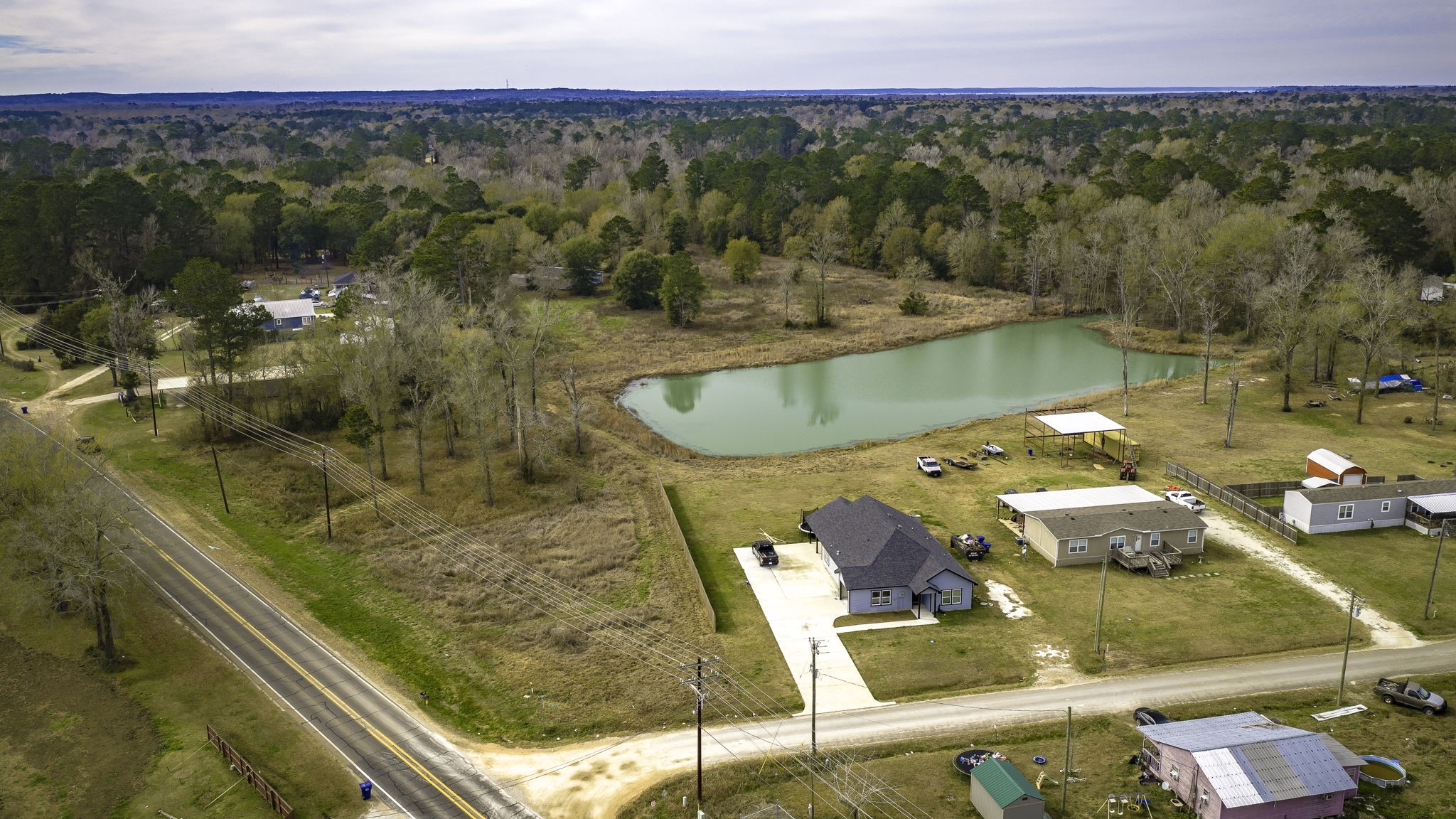 276 Hoot Owl Hollow Road Goodrich, TX 77335 - Photo 13 of 27 a view of a swimming pool with a lake