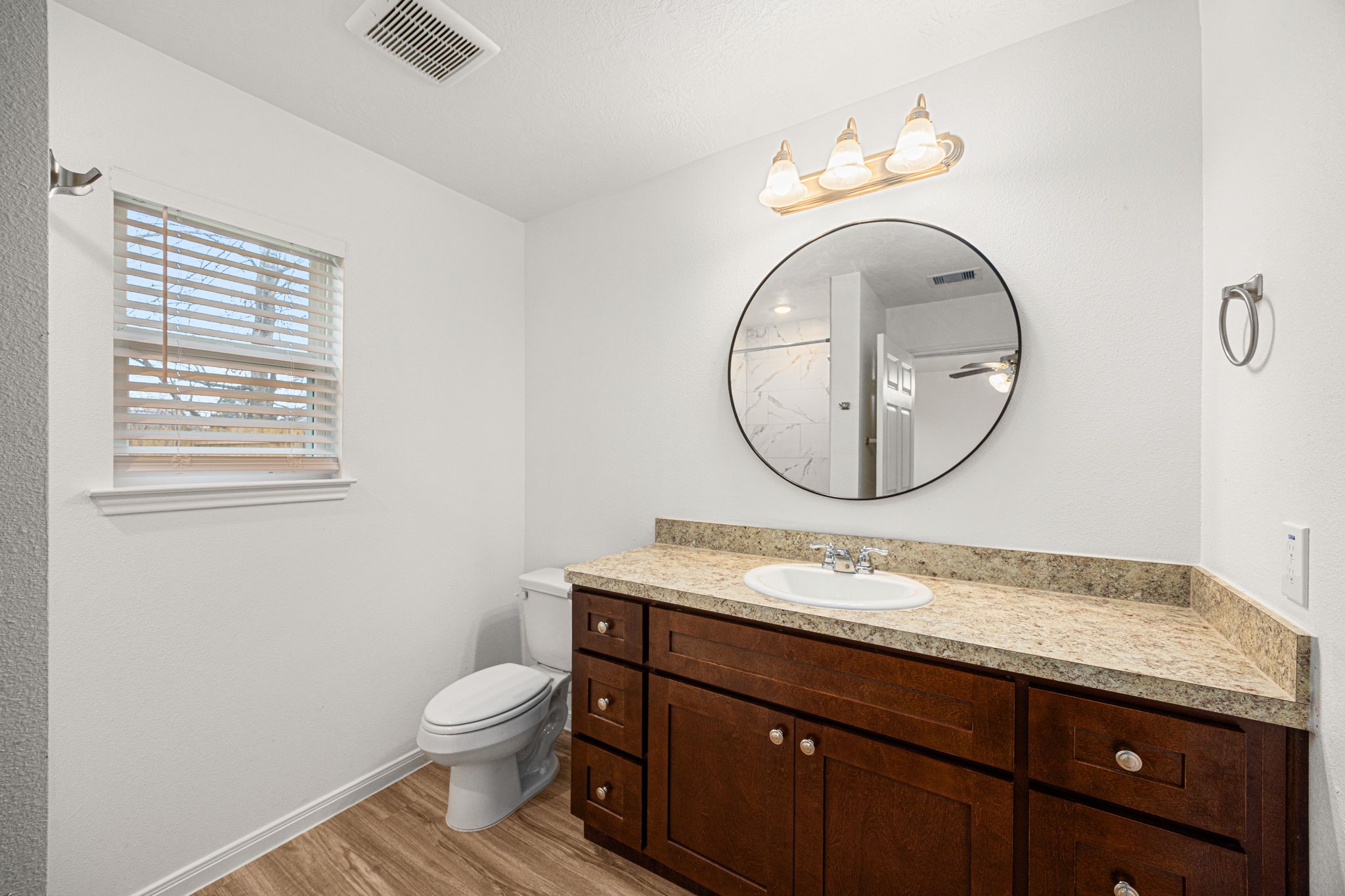 23507 Prairie Bird Drive Spring, TX 77373 - Photo 23 of 30 a bathroom with a granite countertop toilet sink mirror and vanity