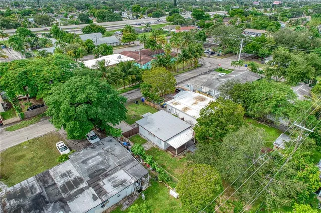 an aerial view of a house with a yard and lake view