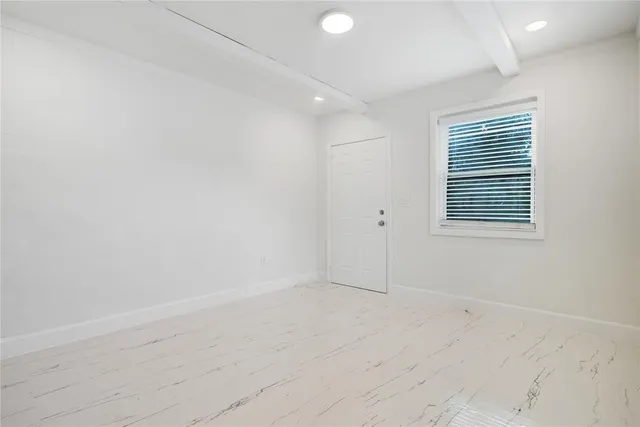 a kitchen with white cabinets stainless steel appliances and a window