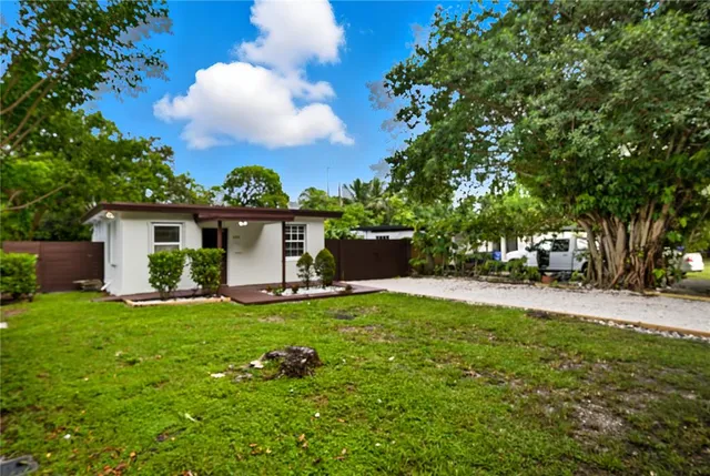 a view of a house with a yard and sitting area
