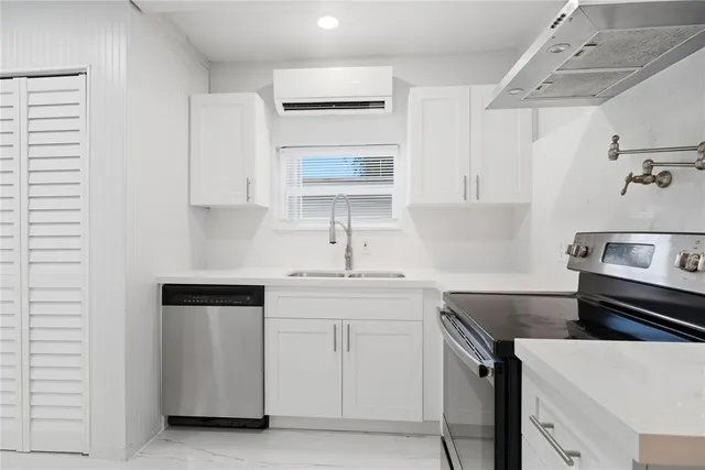 a view of a kitchen with a sink and a stove top oven