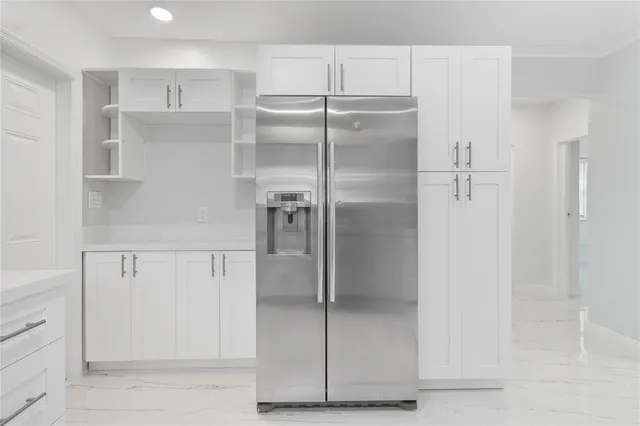 a white toilet sitting next to a white cabinet