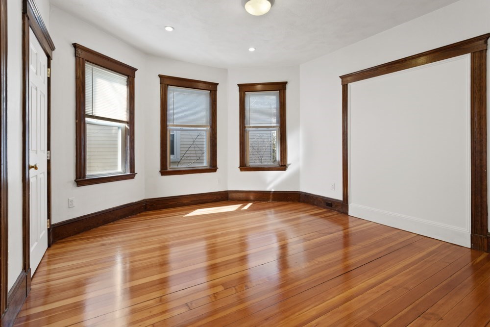 87 Bailey Street, Unit 2 Boston, MA 02124 - Photo 12 of 18 a view of an empty room with wooden floor and a window