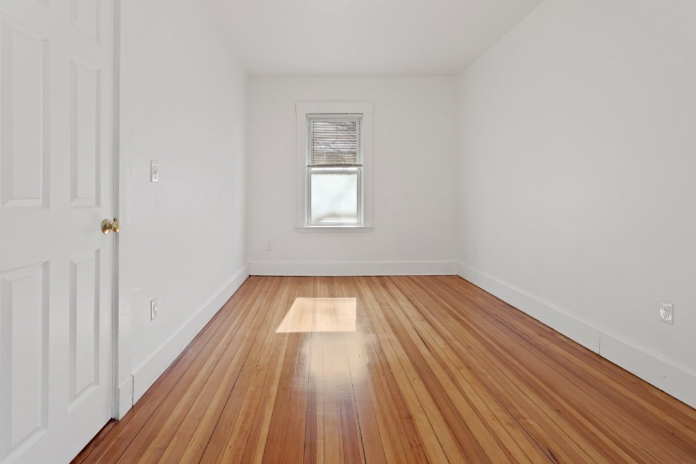 87 Bailey Street, Unit 2 Boston, MA 02124 - Photo 14 of 18 a view of a room with wooden floor and window