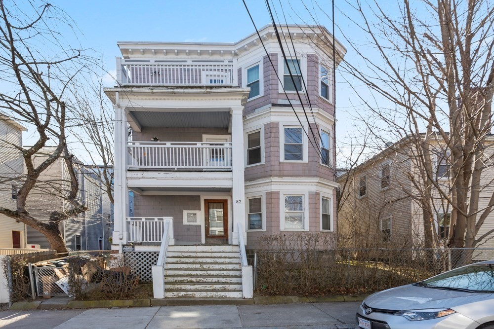 87 Bailey Street, Unit 2 Boston, MA 02124 - Photo 5 of 18 a front view of a residential apartment building with a yard