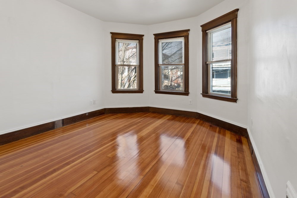 87 Bailey Street, Unit 2 Boston, MA 02124 - Photo 9 of 18 a view of empty room with wooden floor and fan