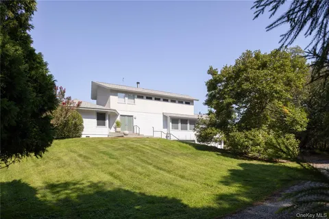 an aerial view of a house with a yard and lake view