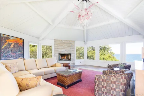 a living room with furniture fireplace and a large window
