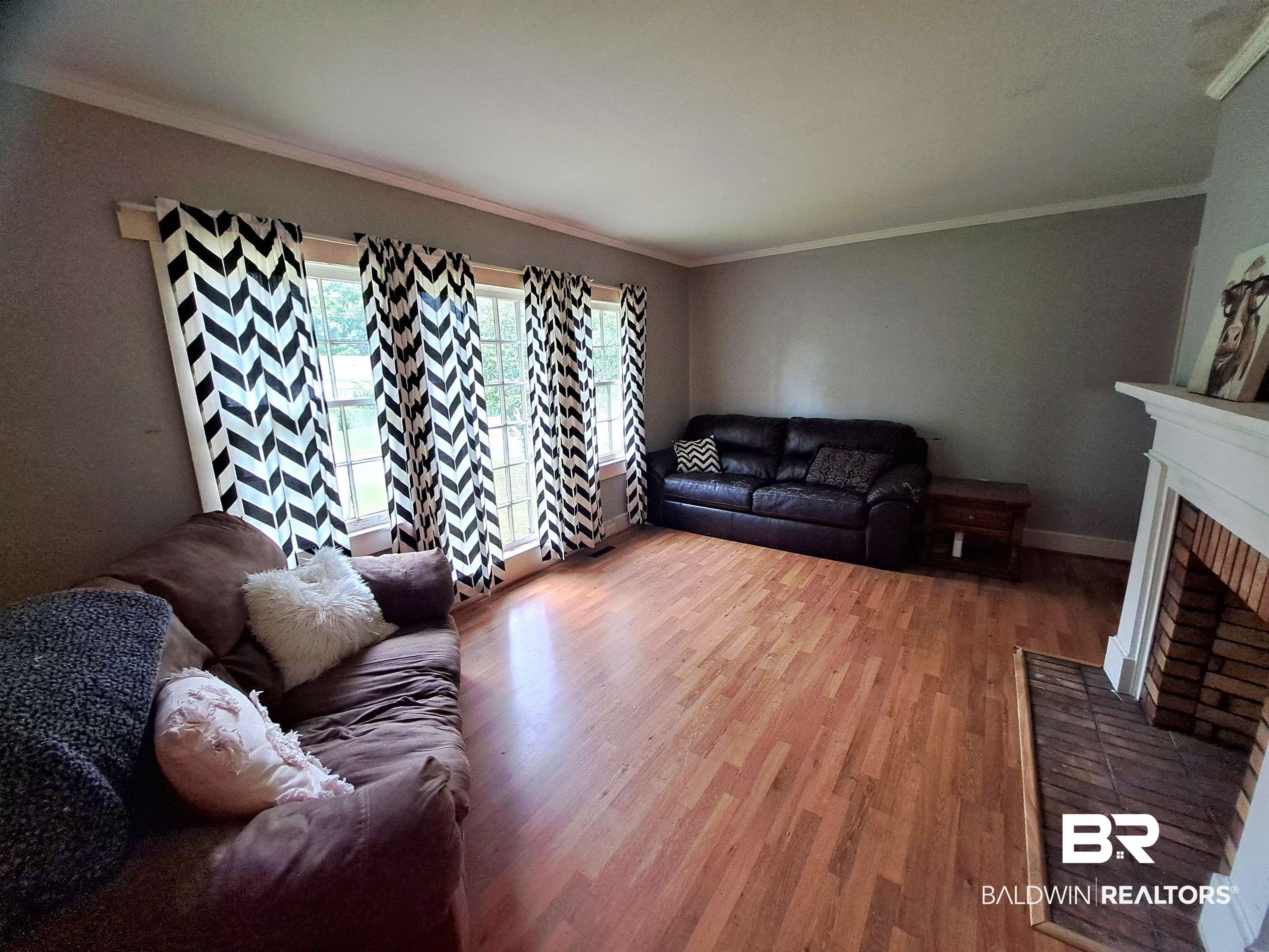 309 Bellview Avenue Evergreen, AL 36401 - Photo 7 of 27 Living room with crown molding, wood finished floors, and a fireplace