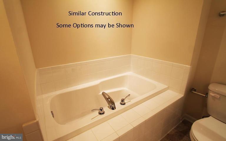 0 Rumbling Rock Road Hedgesville, WV 25427 - Photo 22 of 28 a bathroom with a tub and a sink