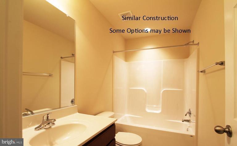 0 Rumbling Rock Road Hedgesville, WV 25427 - Photo 25 of 28 a bathroom with a sink mirror and a bathtub