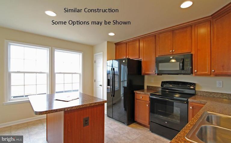 0 Rumbling Rock Road Hedgesville, WV 25427 - Photo 6 of 28 a kitchen with granite countertop a refrigerator stove and microwave