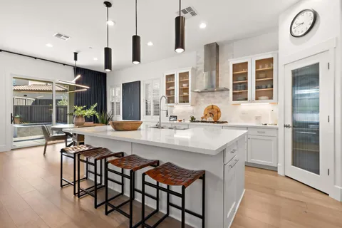 a kitchen with stainless steel appliances granite countertop a stove and a refrigerator