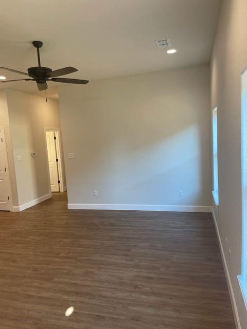 7326 Mountain View Road, Unit 7328 Abilene, TX 79602 - Photo 2 of 15 a view of an empty room with wooden floor and a ceiling fan