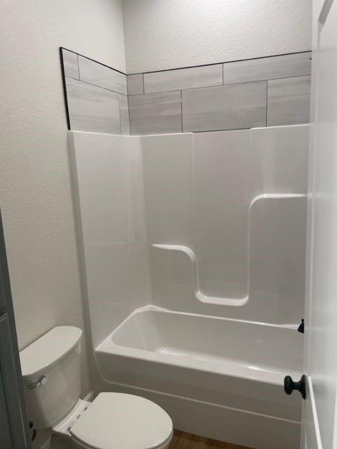 7326 Mountain View Road, Unit 7328 Abilene, TX 79602 - Photo 10 of 15 a bathroom with a toilet and a bathtub