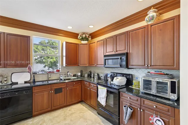 a kitchen with a sink stove and cabinets