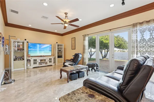 a living room with furniture tv and a large window