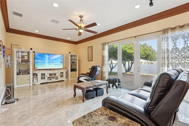 a living room with furniture tv and a large window