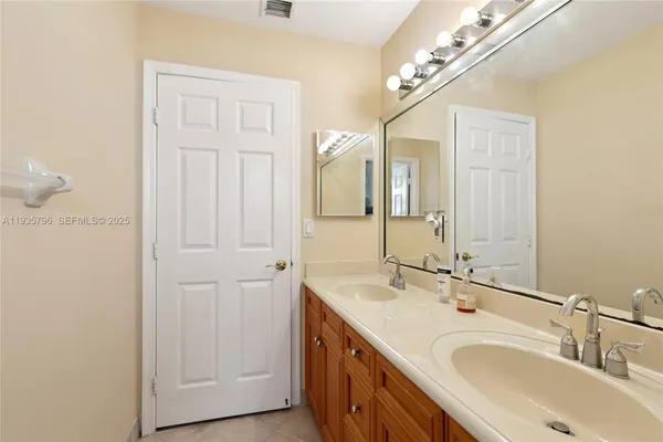 a bathroom with a double vanity sink and a mirror